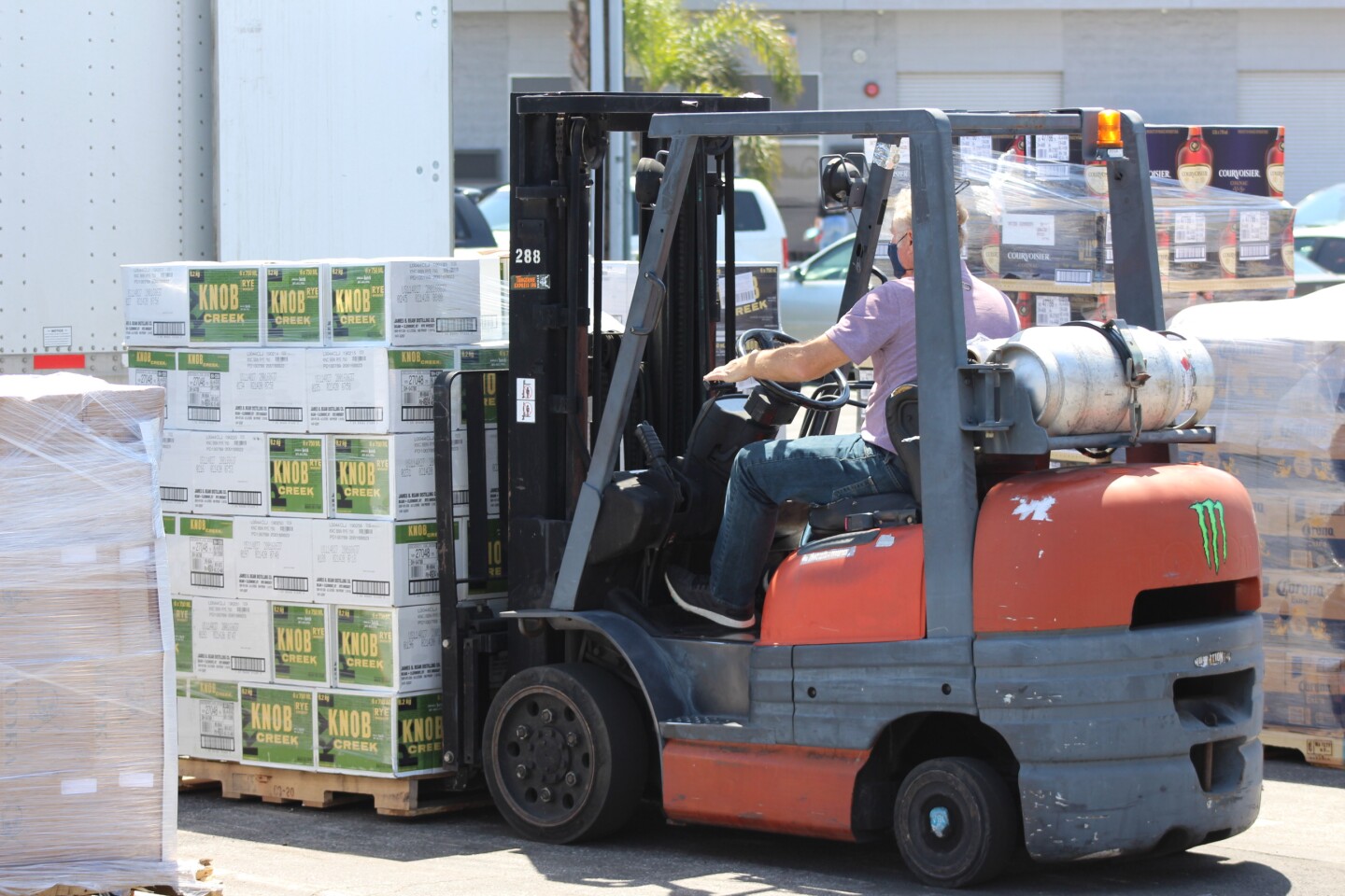 Victor Garcia, a manager with Del Rey Beverage Distributors, unloads a a recent shipment. Garcia says business is up by double digits. | Karen Foshay