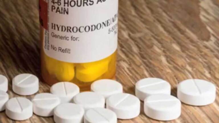 Hydrocodone bottle and loose tablets. | Democracy Now