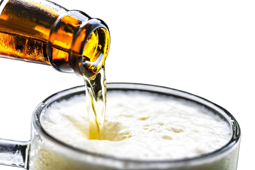 Pouring beer from bottle to glass | Credit: sezer ozger, iStock