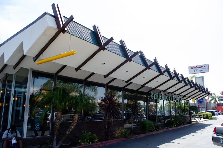 A photo of a Starbucks Coffee location, with Googie-style mid-century modern architecture. 