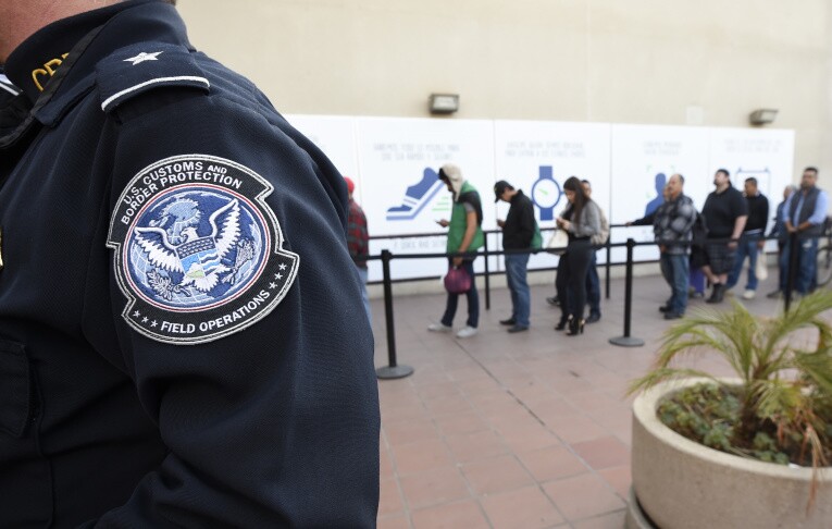 Pedestrians crossing from Mexico into the United States at the Otay Mesa Port of Entry wait in line on Dec. 10, 2015. | Denis Poroy/AP