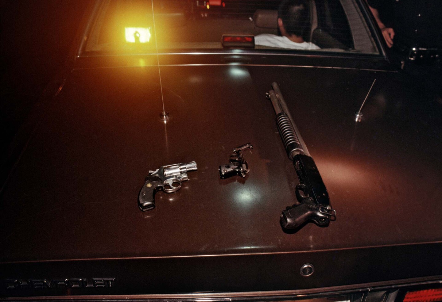The LAPD CRASH Unit, working with the federal Bureau of Alcohol, Tobacco, Firearms to get guns off the street, confiscated these weapons from alleged 18th Street Gang members in Pico-Union. | Joseph Rodriguez