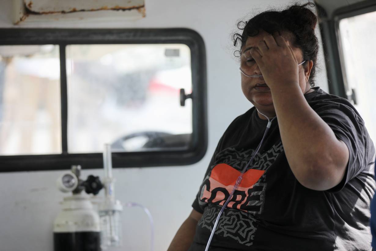 A patient suffering from the coronavirus disease (COVID-19) receives oxygen inside an ambulance after she was evacuated from the Vijay Vallabh hospital, which caught fire in Virar, on the outskirts of Mumbai, India, April 23, 2021.