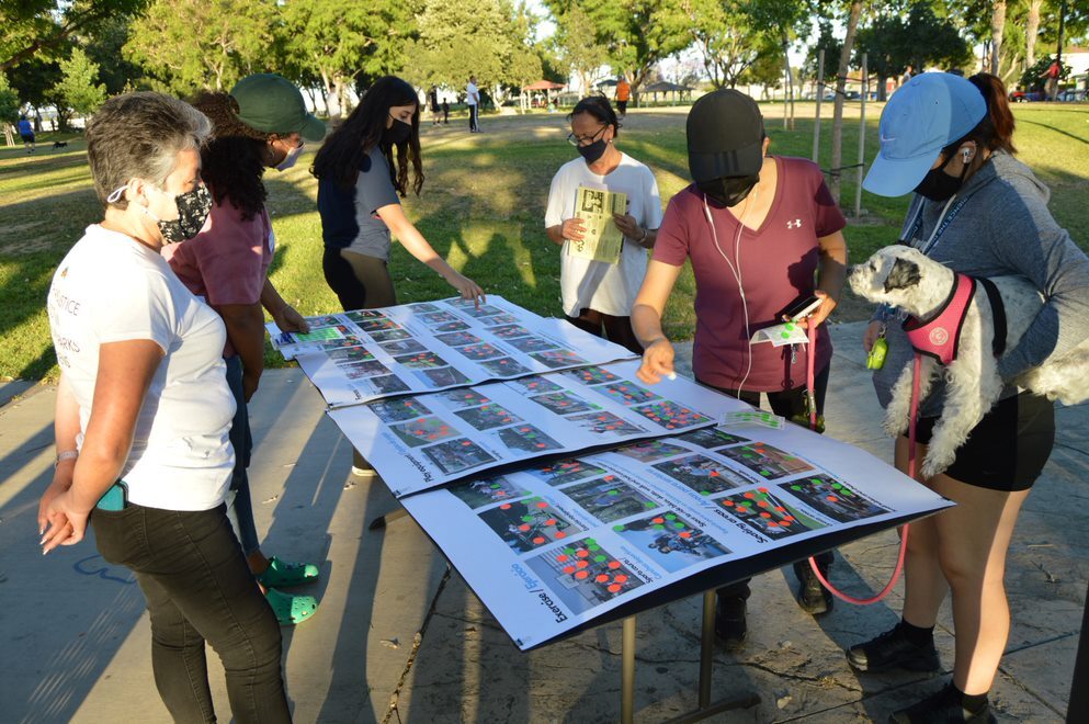 Locals gather around plans for a new arts center at an outdoor space