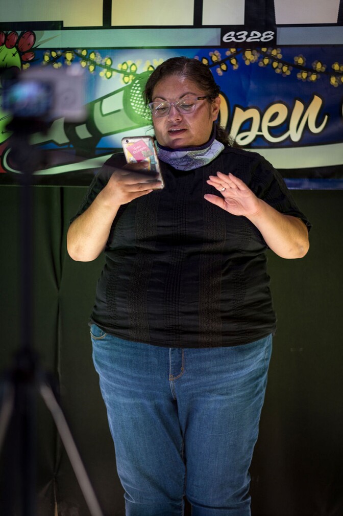 Xitlalic Guijosa-Osuna reads a poem for the tamal lady. | Visual Eyes LA