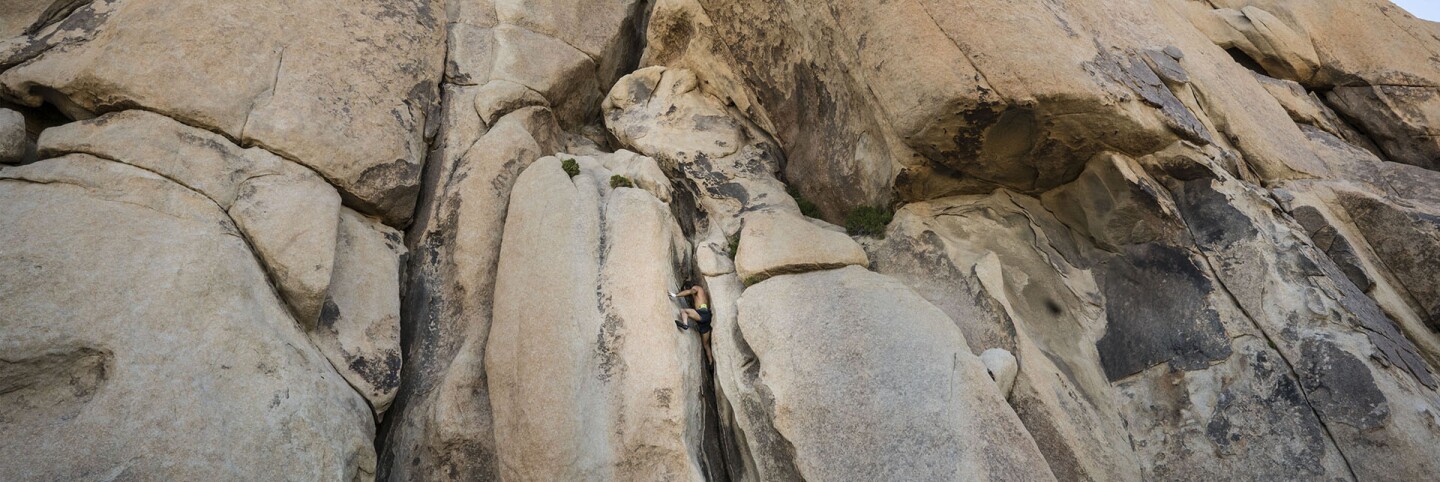 op Image: Alexis Sonnenfeld, a twenty-year resident of Joshua Tree is shown climbing West Chimney, Intersection Rock in opening | Kim Stringfellow