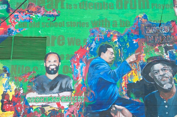 A close up view of Alonzo Davis and Brockman Gallery as part of the historical tableau (alongside Horace Tapscott and Richard Fulton of 5th St. Dicks) on the mural behind the Vision Theater | Photo: Alvaro Parra