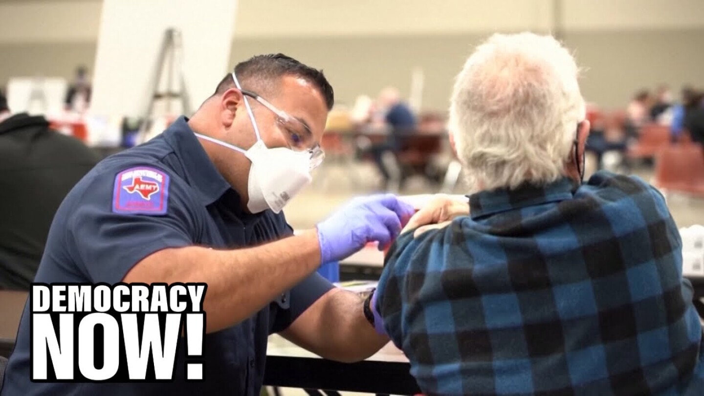 A healthcare worker injects the COVID-19 vaccine into the arm of an elderly patient.