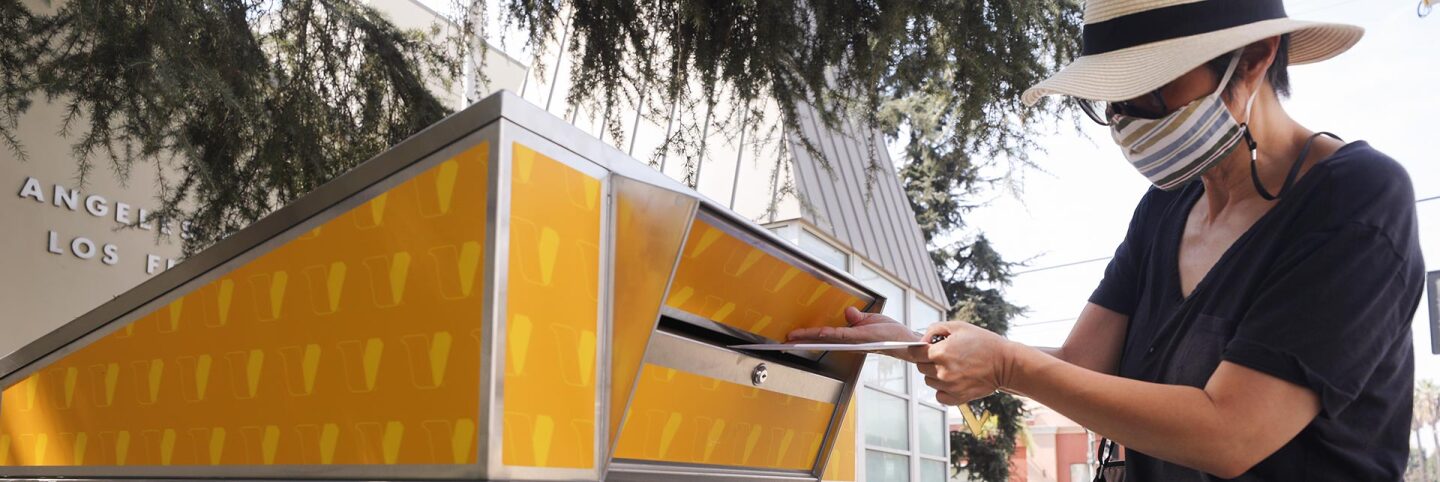 A voter places their ballot in a mail-in ballot dropoff box outside of a library ahead of Election Day on October 5, 2020 in Los Angeles, California. | Mario Tama/Getty Images