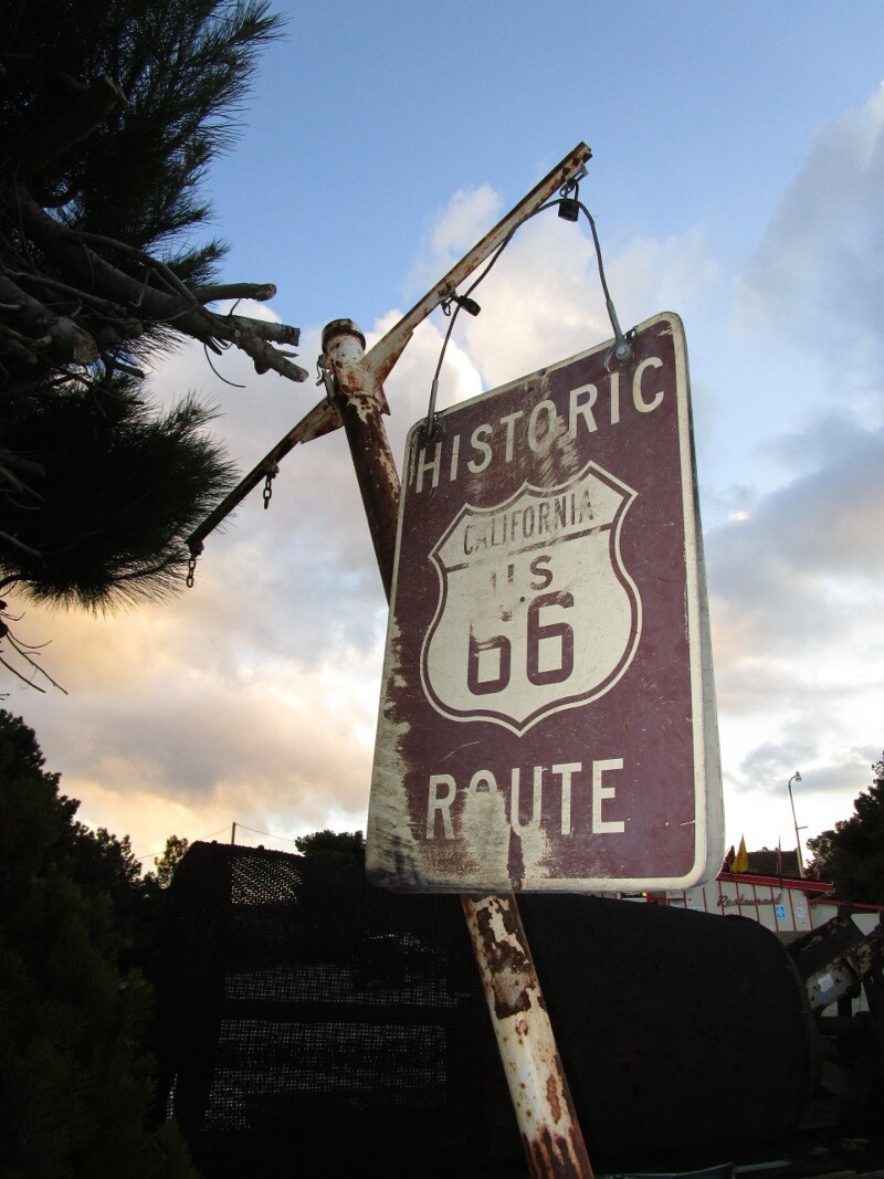 A faded Route 66 sign in front of historic Summit Inn diner, located at the southern end of the Cajon Pass – the trail linking the desert with the California coast through San Bernardino.