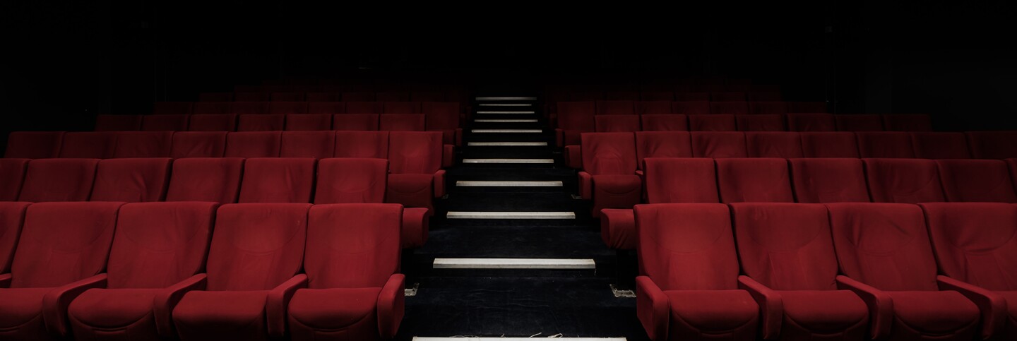 Empty red velvet chairs | Felix Mooneeram / Unsplash