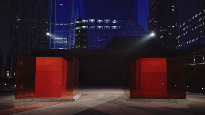 Larry Bell's "Bill and Coo at MOCA’s Nest" is a work of Light and Space art. Here it is seen at night. | Still from Artbound "Light & Space" ab s11