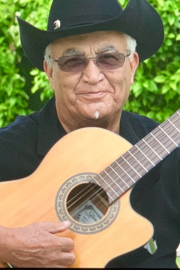 Eliades Ochoa playiing a guitar. | From "Eliades Ochoa: From Cuba to the World"