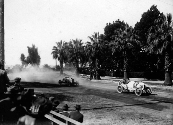 Racing automobiles turn onto Wilshire Boulevard, then named Nevada Avenue, from Ocean Avenue in Santa Monica in 1910. Courtesy of the USC Libraries - California Historical Society Collection.