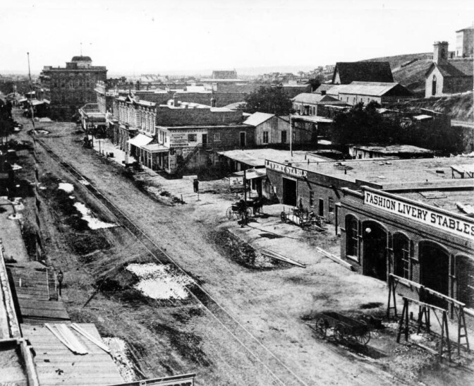Stables occupy prime commercial real estate in this 1874 view of Main Street, just north of Temple. Courtesy of the USC Libraries - California Historical Society Collection.