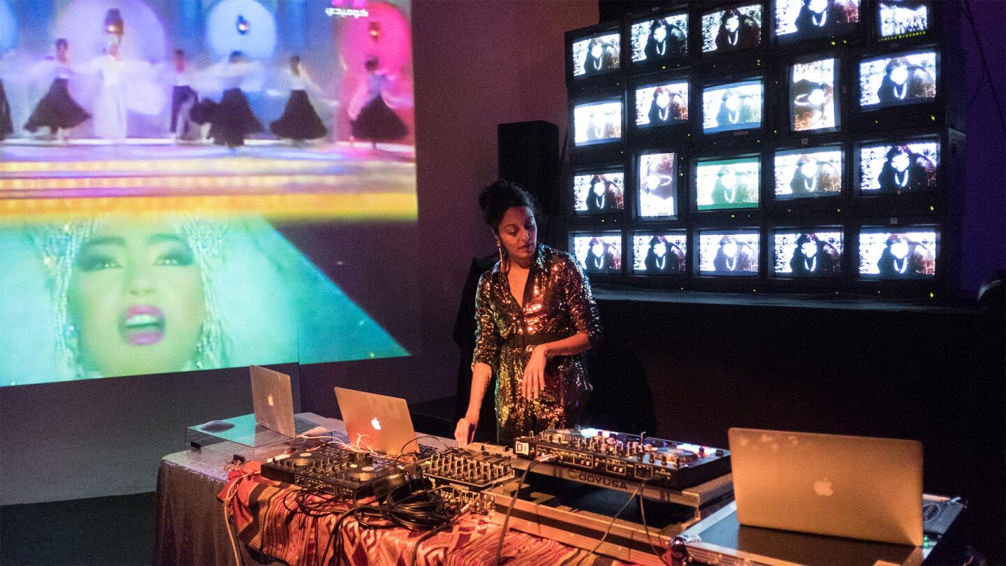 A woman deejays at a party