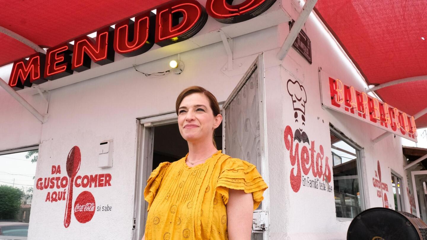 Pati Jinich standing outside a restaurant.