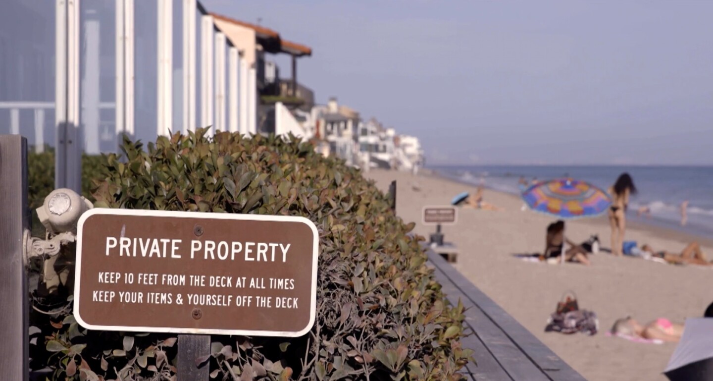 Private Property sign in foreground with beach behind it | Still from "Access Denied" on SoCal Connected