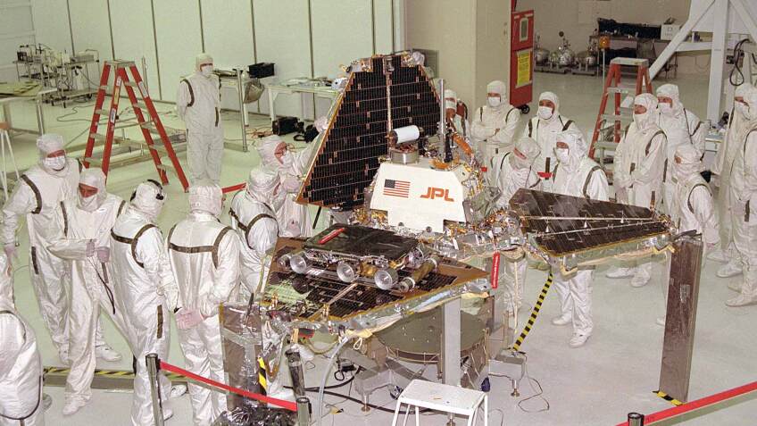 October 1996, Jet Propulsion Laboratory workers are closing up the metal "petals" of the Mars Pathfinder lander. The Sojourner small rover is visible on one of the three petals. | NASA/Flickr