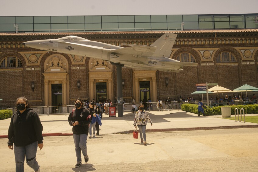 A military plane hangs outside the California Science Center.