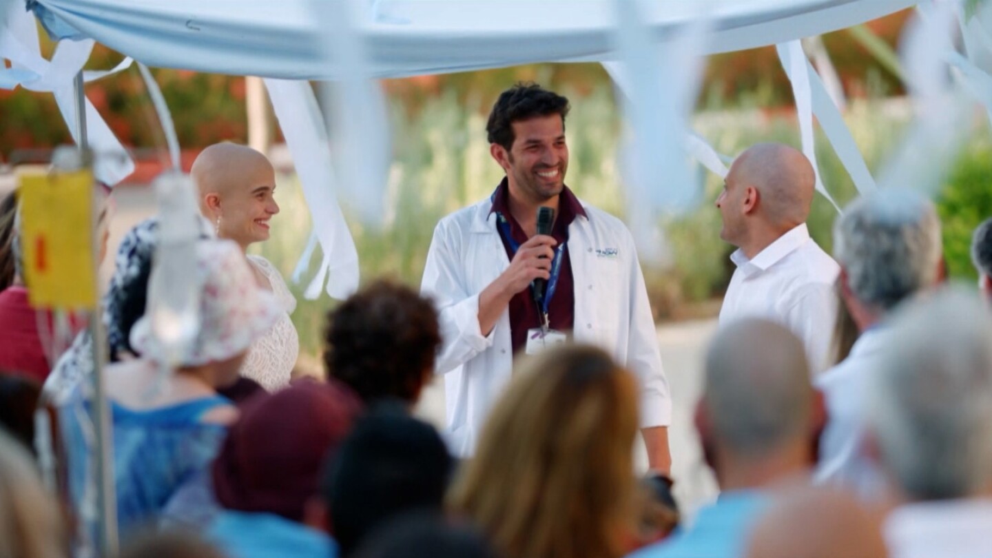 Michal and Eran with their doctor at their fake wedding.