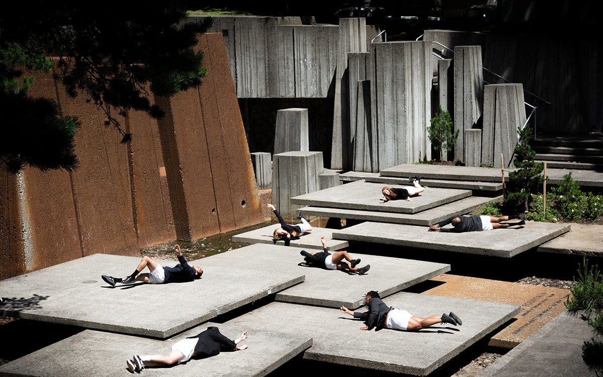 Several Heidi Duckler Dance Northwest dancers lie on the ground artistically in matching black and white outfits. | Courtesy Heidi Duckler Dance