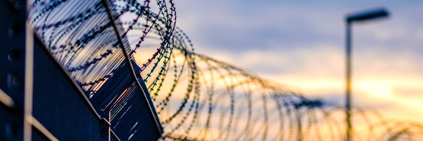 A fence with barbed wire. | iStock via Getty Images