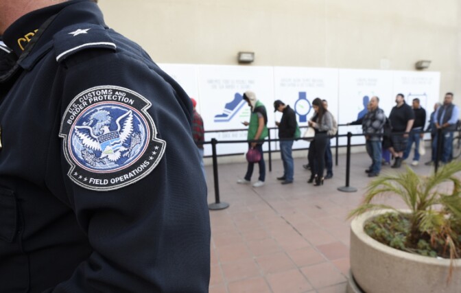 Pedestrians crossing from Mexico into the United States at the Otay Mesa Port of Entry wait in line on Dec. 10, 2015. | Denis Poroy/AP