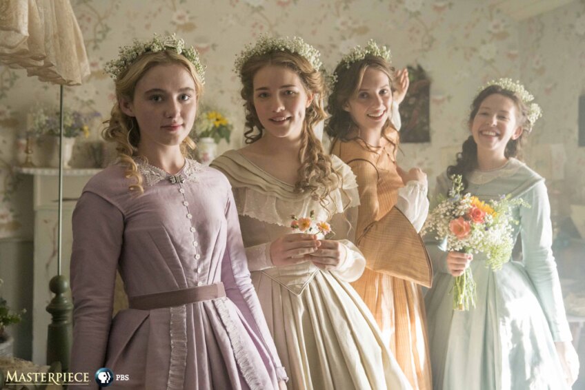 Scene from Little Women that shows 4 women wearing dresses and flower head adornments