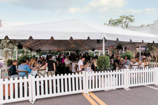 iners eat in a tent set up on a street outside the Forbici Modern Italian restaurant in Tampa, Florida, in May amid the coronavirus pandemic. | Handout photo by Amy Pezzicara / Pezz Photo