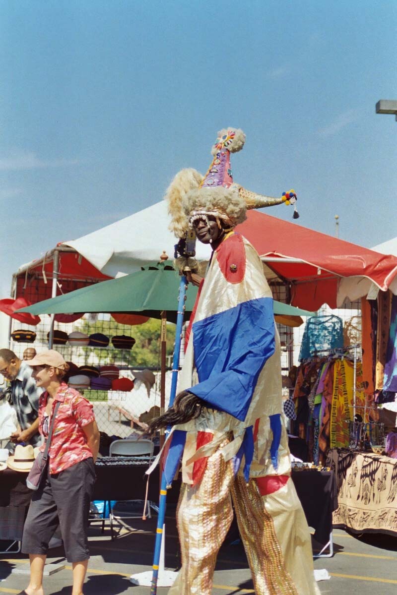 A stilt-walker walks around at a past Watts Towers festival. | Courtesy of Watts Towers Art Center