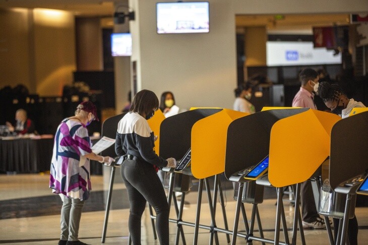 Voters cast their ballots at the vote center inside Staples Center. | Chava Sanchez/LAist